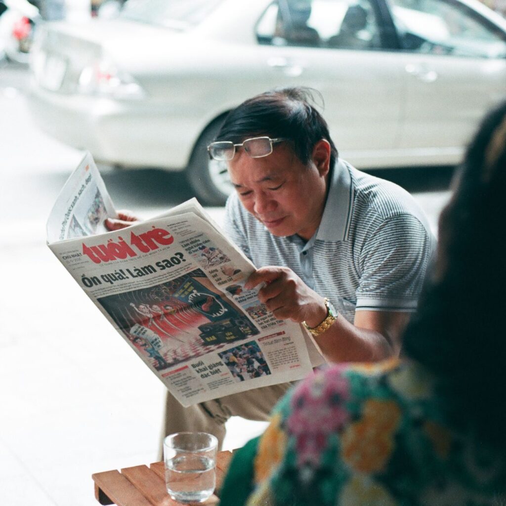 newspaper reading hands closeup